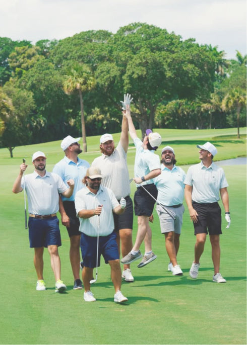 A group of golfers hi-fiving