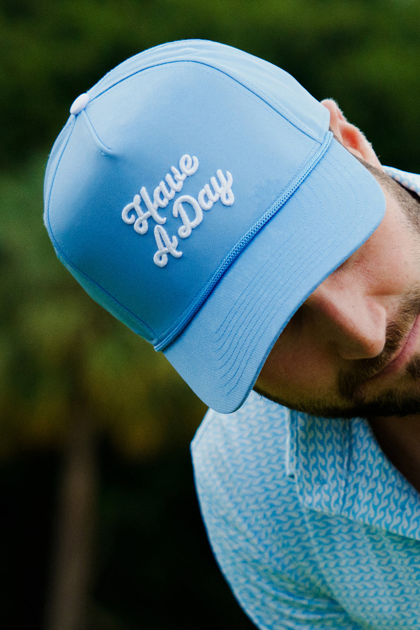 Golfer wearing hat that says "Have a Day"